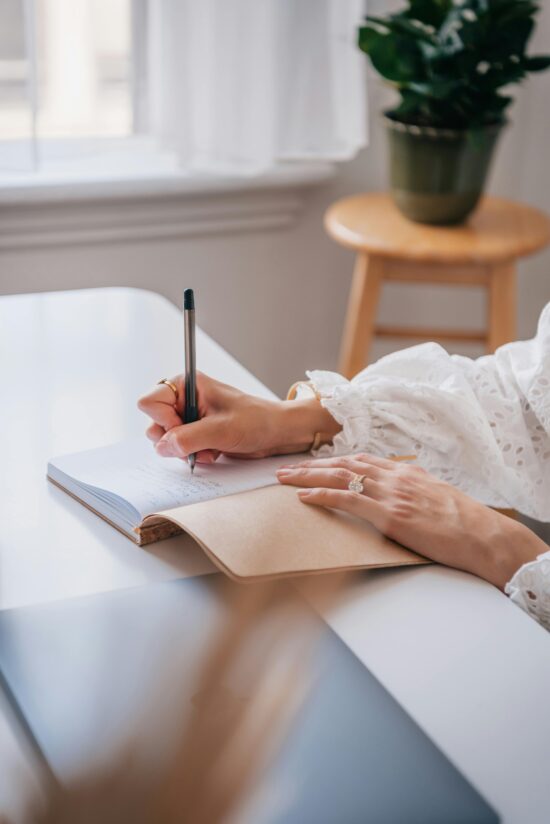 Woman writing in a journal during trauma therapy session